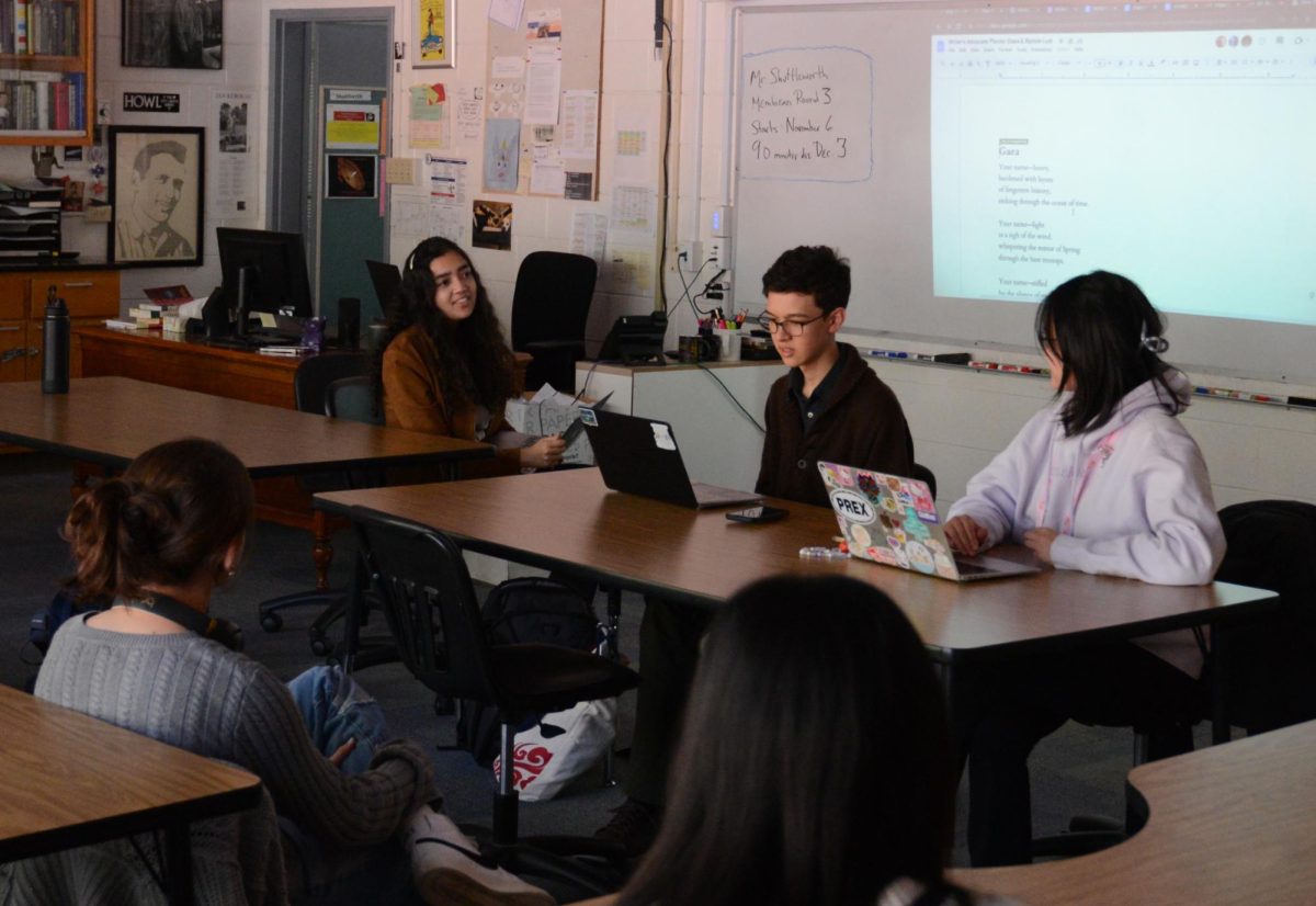 Writers’ Advocate officers Tanisha Singh (12), Felix Chen (11) and Sydney Ling (12) analyze a mythology-themed poem Gaea for entry into the Scholastic Awards. Participants discussed how to use literary devices that communicated the writers voice without sacrificing clarity for the reader.