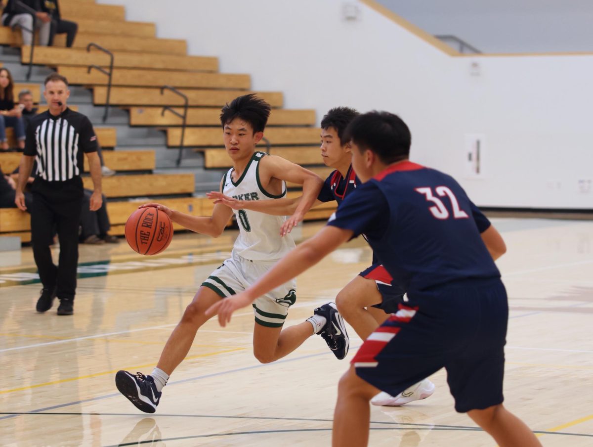 Bowen Xia (11) blows by a defender on a drive to the basket. Bowen is a team co-captain this year and plays the point guard position.