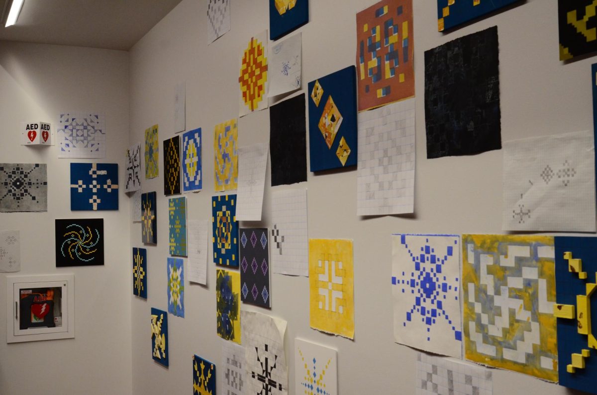 The RPAC gallery displays artwork depicting yellow stars in blue space. Karimi worked with students to highlight the beauty and intricacies of stars.