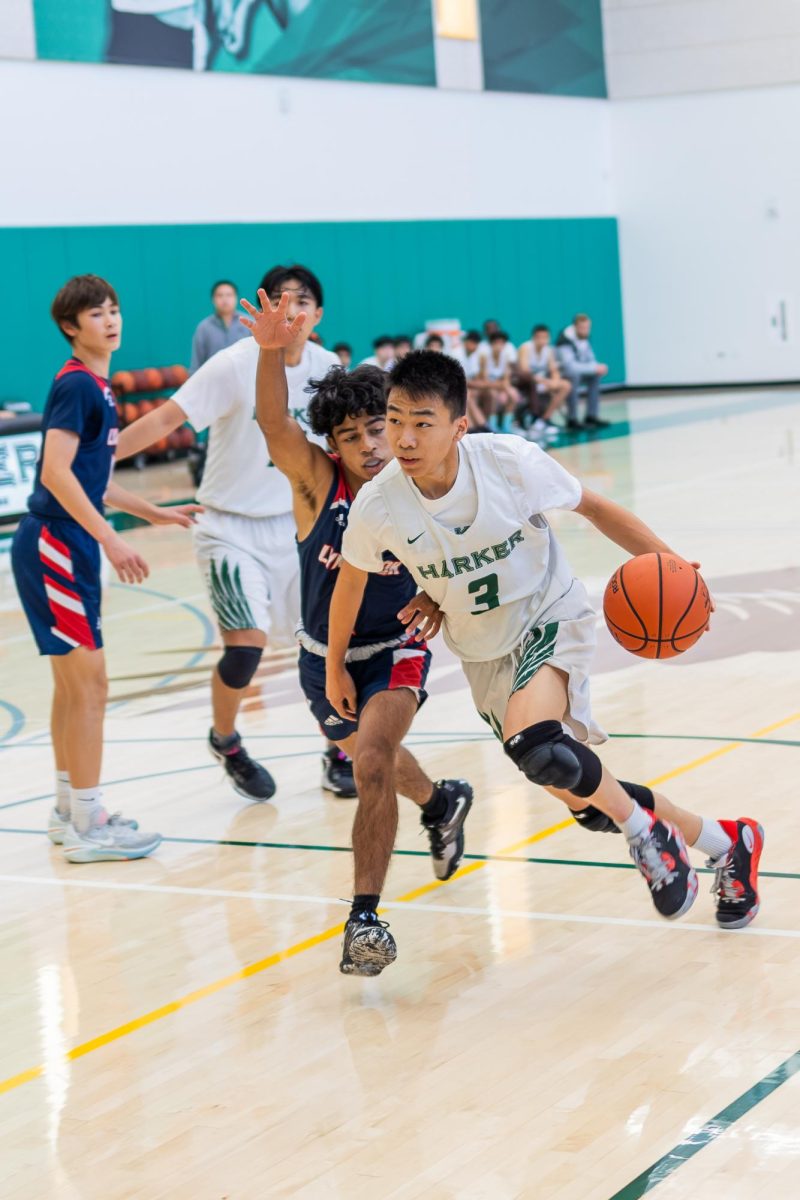 Caden Ruan (10) drives to the basket through the Lynbrook defense. As the Eagles' point guard, Caden directed the offense by communicating plays for a majority of the game.