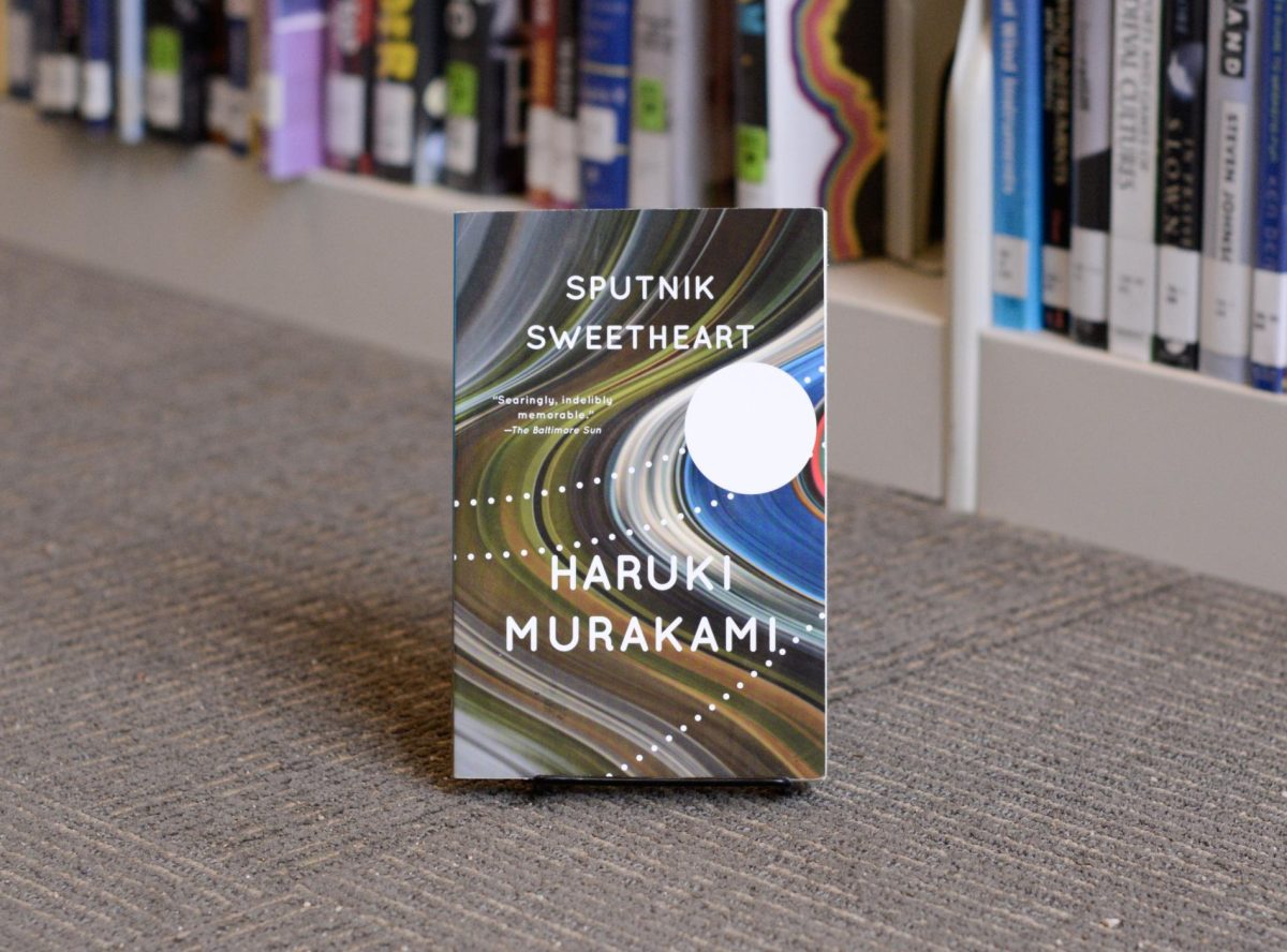 As+an+avid+Murakami+reader%2C+reading+%E2%80%9CSputnik+Sweetheart%E2%80%9D+felt+like+reconnecting+with+an+old+friend%3A+comforting%2C+nostalgic+and+moderately+gut-wrenching.+Complete+with+alternate+universes%2C+moon+portals+and+other+typical+Murakami+narrative+devices%2C+the+plot+follows+a+detective-style+pattern+reminiscent+of+earlier+works+like+%E2%80%9CNorwegian+Wood%2C%E2%80%9D+unfolding+with+a+familiarity+that+is+predictable+yet+enjoyable+all+the+same.