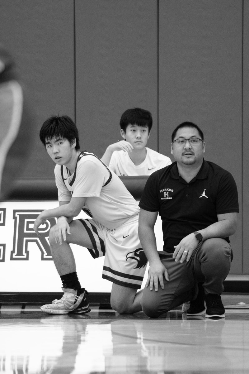 Varsity boys basketball co-captain Kevin Zhang waits to substitute into a game against the Collegiate School. The Eagles fell short in a 49-56 loss at home on Jan. 4. 
