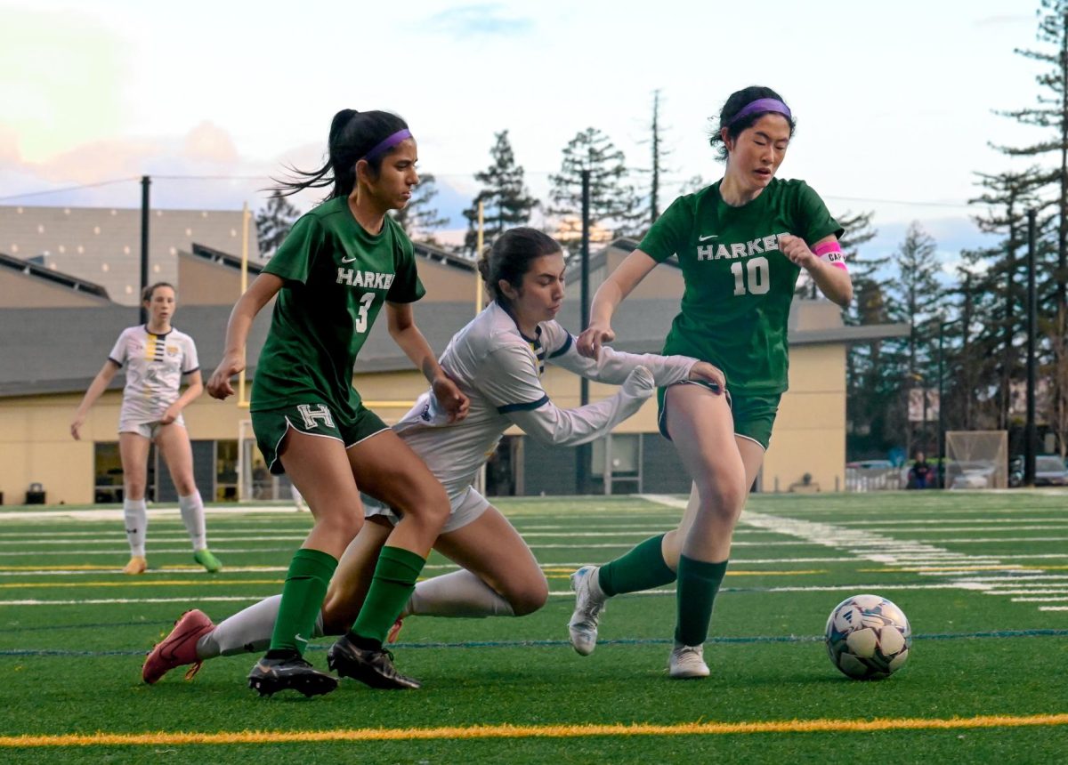 Co-captain Cynthia Wang outruns her opponent during the girls varsity soccer game. Team members sold baked goods throughout the week to fundraise for Camp Okizu. 