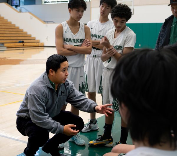 Junior varsity boys basketball head coach Nick Nguyen (15) addresses his players during half time. “I was confident in my ability to be able to coach Harker’s JV team,” Nguyen said. “Elsewhere, I would have been more hesitant and I think I would have had less of an impact than I could have here, which is what drew me to take the job.