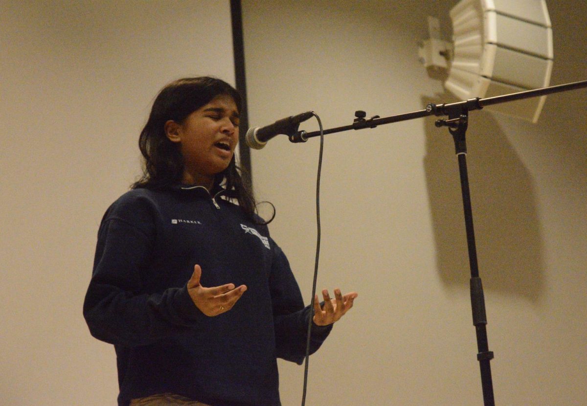 Dhanya Ramanan (9) recites Love Song of the Bat with Vertigo by Martín Espada for Harkers Poetry Out Loud competition on Jan. 31. Of the eleven contestants, Eric Zhang (11) and Iris Fu (12) advanced to the Santa Clara County regional round.