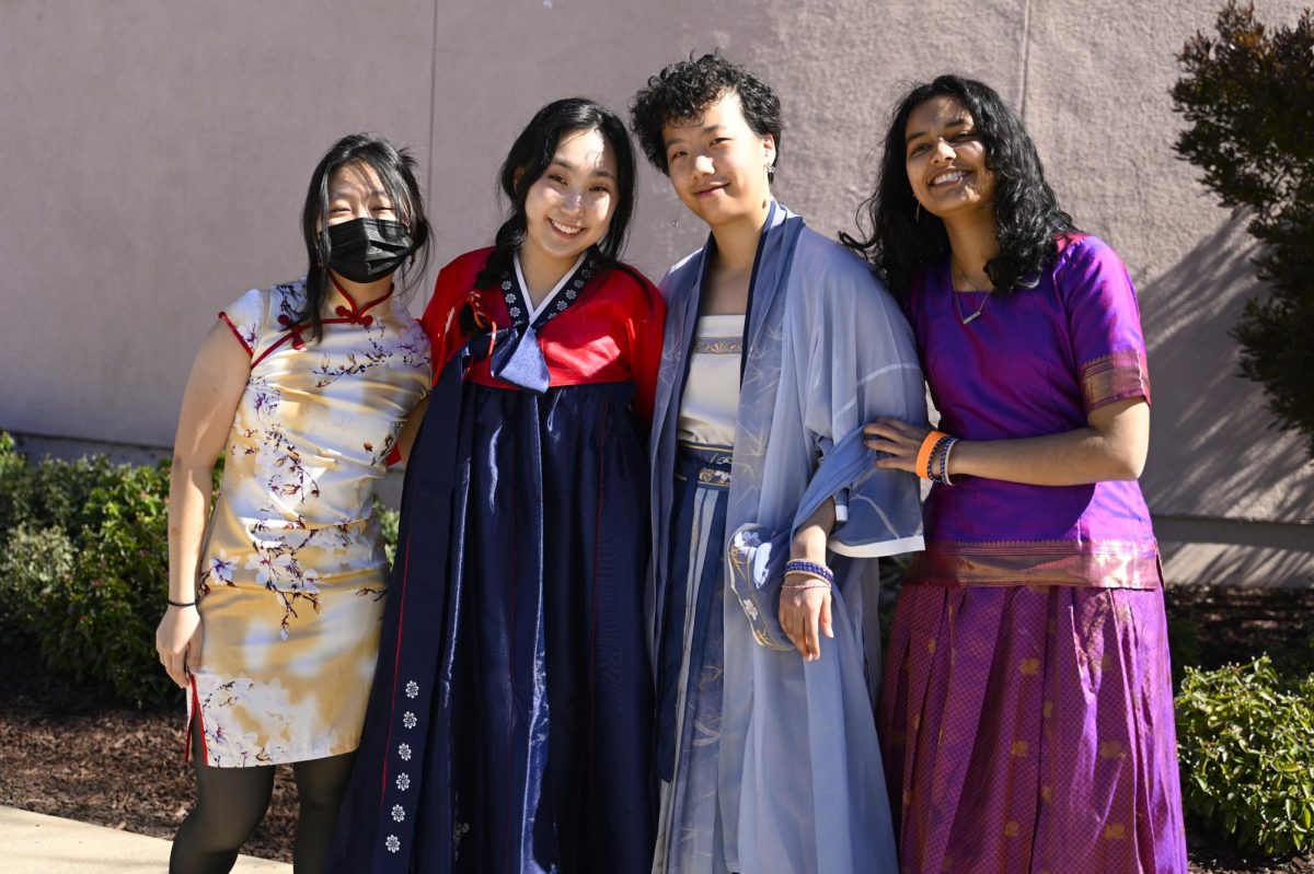 Alicia Ran (11), Mina Okamoto (12), Yifan Li (11) and Harshini Chaturvedula (12) smile and pose for a photo together. Many students wore traditional attire from their cultures to celebrate Culture Day.