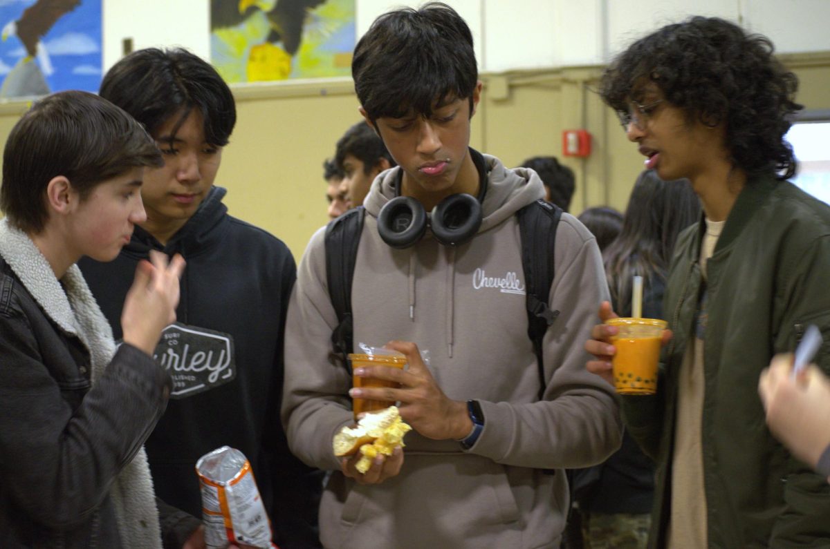 Sophomores Lucho Caballero, David Li, Rishi Radhakrishna and Ram Batchu talk while eating snacks and drinking boba from the sophomore advisory potluck. Advisories brought snacks such as homemade brownies, Bundt cakes, chips and pastries.