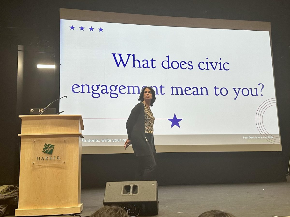 Assistant upper school division head Kelly Horan introduces the senior LIFE session on Feb. 6  about civic engagement and financial responsibility in Patil Theater. Speaker Mark Janda discussed the logistics of voter registration.