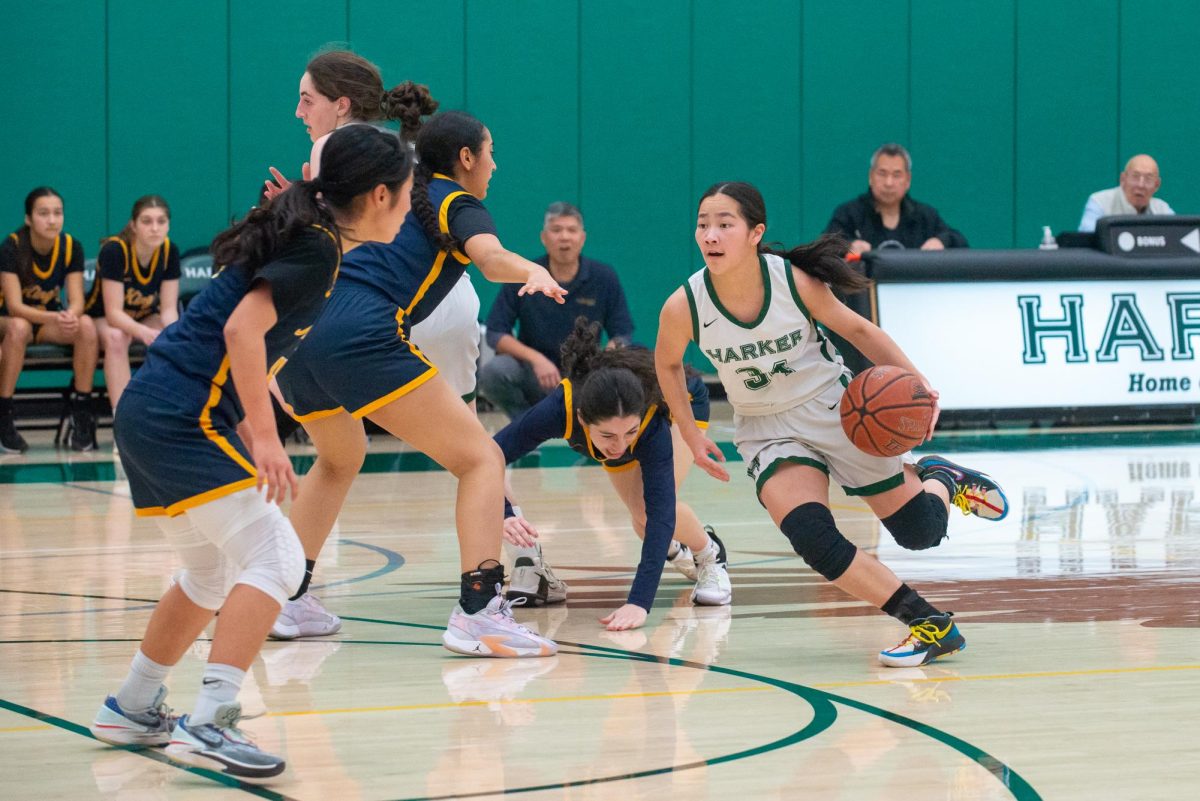 Point guard Isabella Lo (11) dribbles off of a screen by center Emily Mitnick (11) to lose a defender behind her. Emily set screens to run pick and roll offensive strategies.