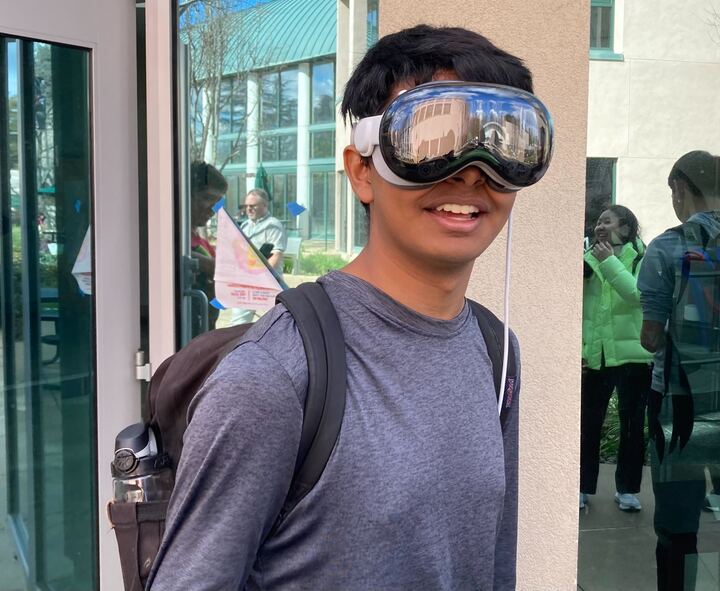 Kabir Ramzan (12) dawns the new Apple Vision Pro at school, experimenting with its various features. The headset enables users to run applications, FaceTime, and even watch movies, all controlled by simple gestures.
