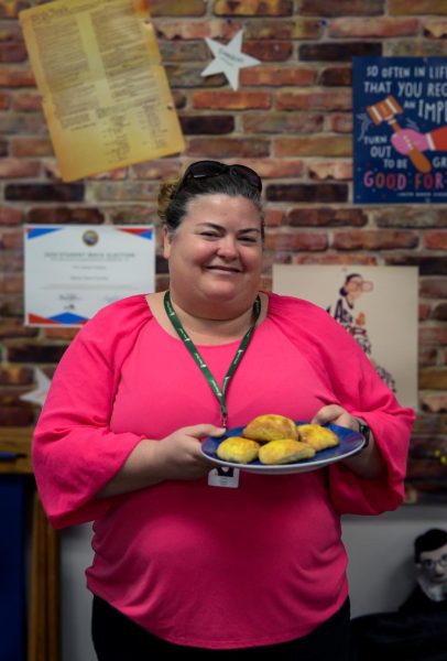 History and social science teacher Carol Green stands with a plate of homemade scones. “When you prepare a dish for someone, you are sharing a part of yourself with them, and youre showing that you care for them, Green said.