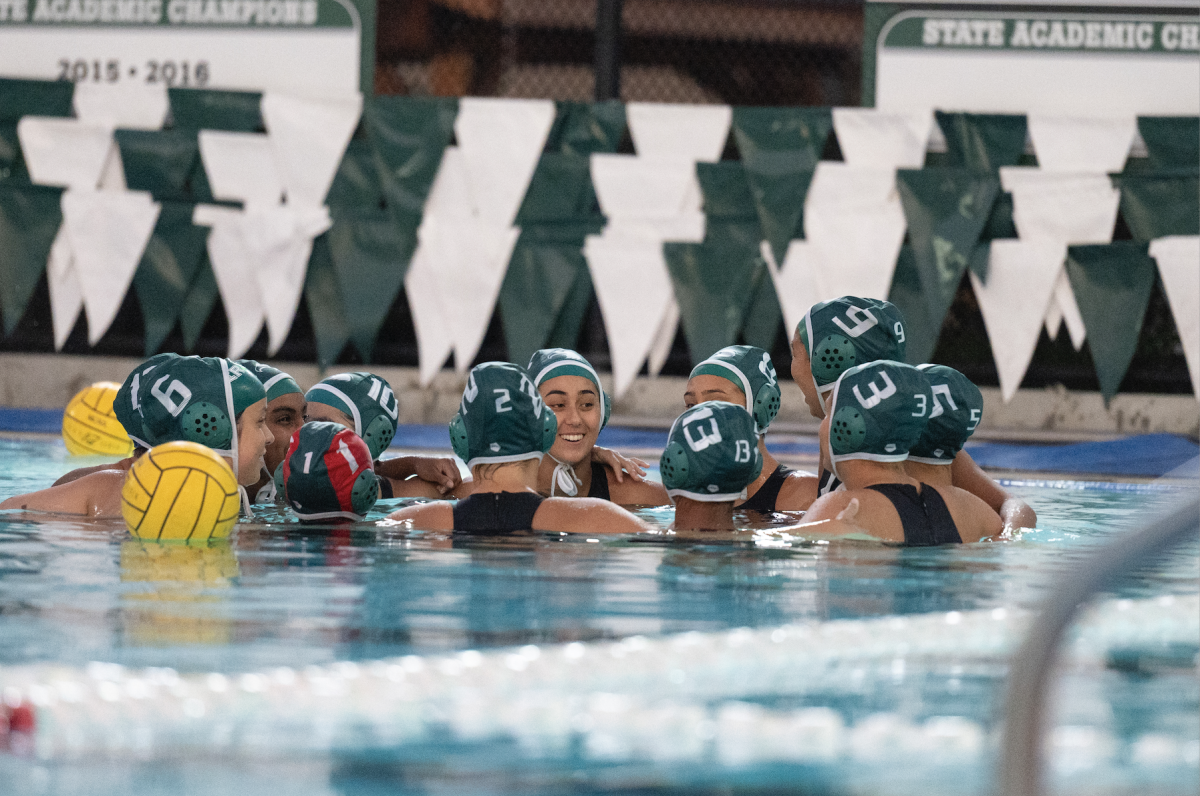 The girls varsity water polo team huddles during a timeout in the boys varsity water polo game against Palo Alto High School on Oct. 19th. The girls varsity water polo team qualified for CCS but lost in their semifinal game against Aptos High School on Nov. 7th.