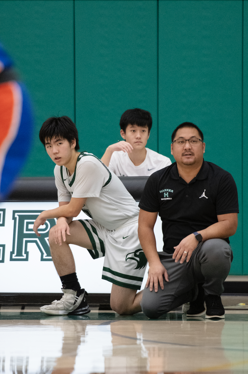 Varsity boys basketball co-captain Kevin Zhang waits to substitute into a game against the Collegiate School. The Eagles fell short in a 49-56 loss at home on Jan. 4. 