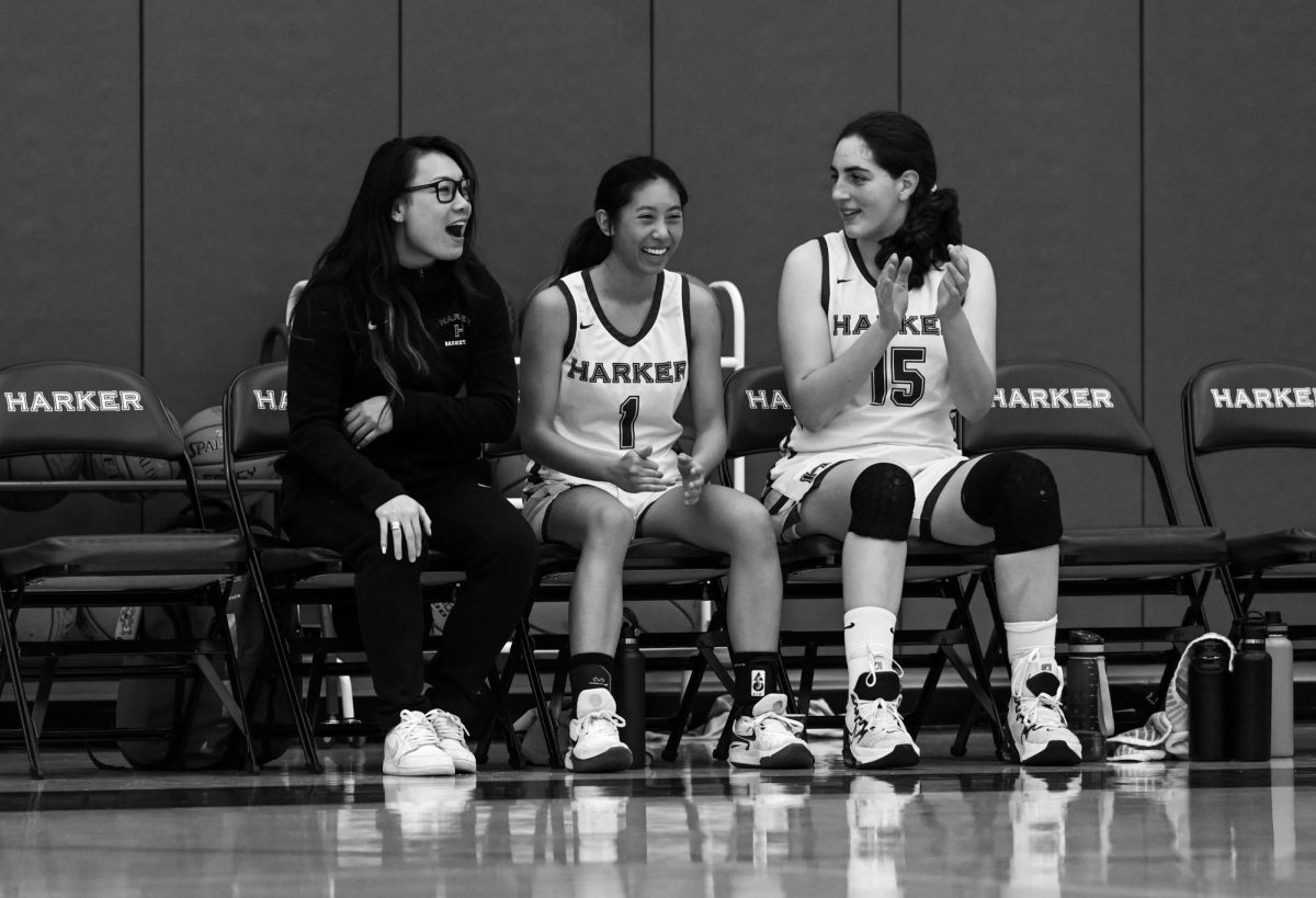 Varsity girls basketball co-captains Claire Miao (12) and Emily Mitnick (11) clap for the team from the sidelines. The team qualified for CCS after defeating Monte Vista 60-42 at home on Jan. 13. 