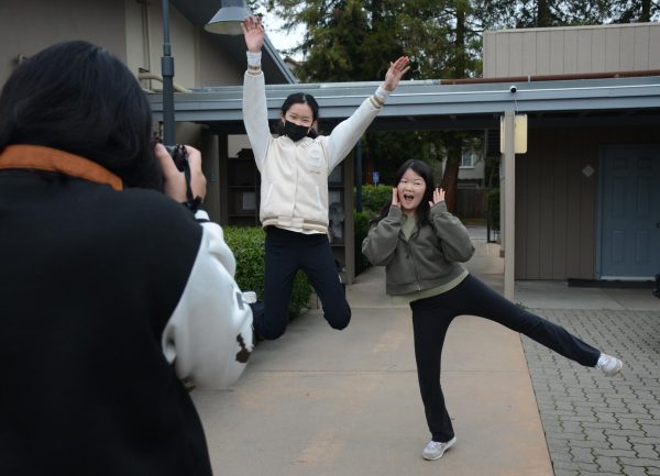 Introduction to Journalism student Sarah Wang (9) captures fellow classmates Emma Lee (9) and Victoria Li (9) jumping midair. During photographer Mark Murray’s visit, students practiced shooting action photos and capturing motion.