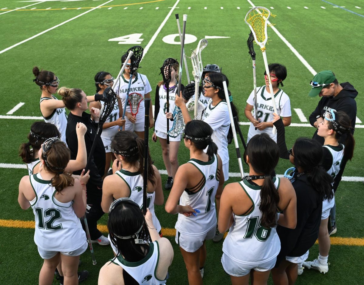 Roma Bhanot (9) leads the varsity girls lacrosse team’s cheer during a huddle after the first quarter. “The culture just seems really relaxed because of the players and the coaches,” Roma said. “A lot of the players are new their freshman year, so I definitely got a lot of help from them, even before the season started. 
