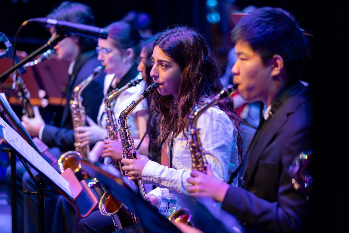Bahar Sodeifi (11) and Kyle Li (11) play the saxophone during Jazz Bands performance at the Essentially Ellington Festival. Harker performed Manceta by Dizzy Gillespie. (Provided by Essentially Ellington Festival)