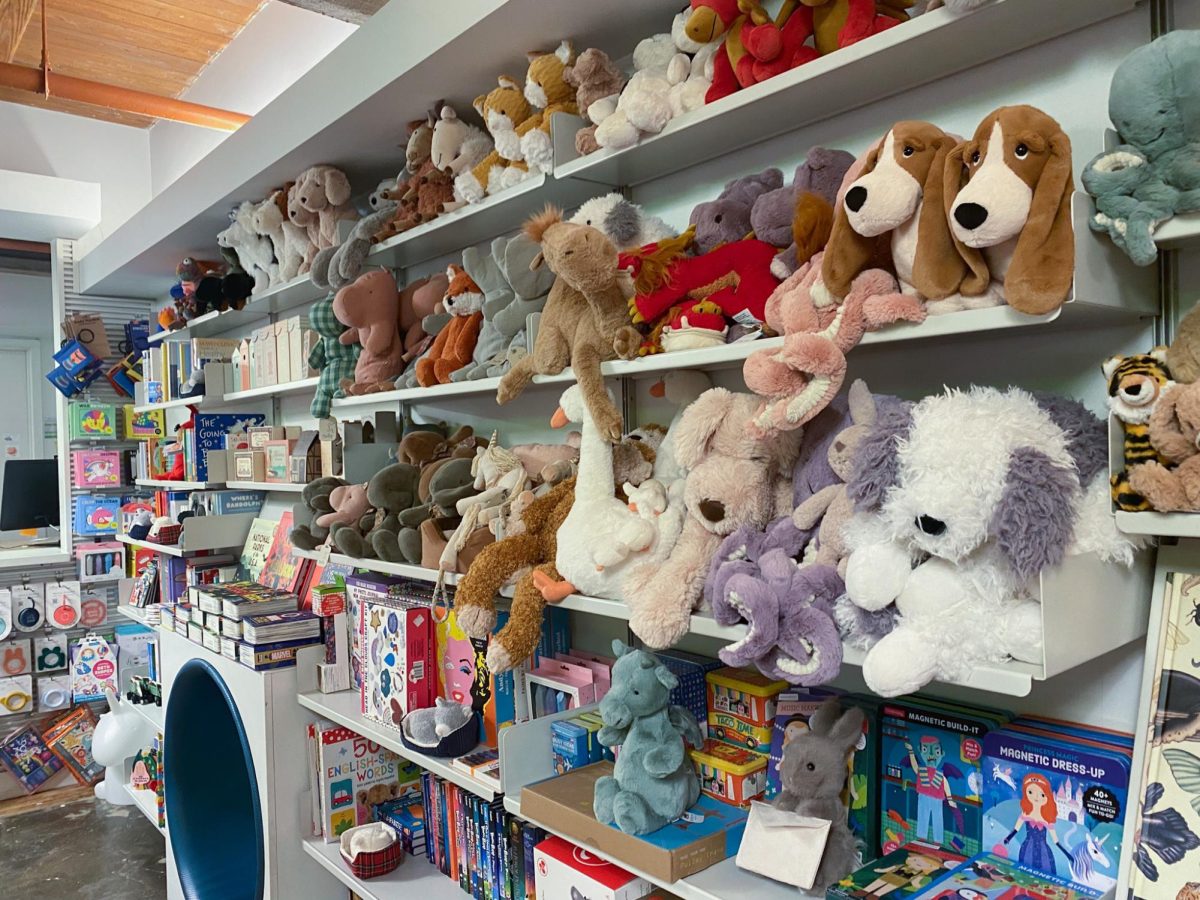 Stuffed animals line a wall of Posman books. For many toursits who are less interested in the selection of books, the stuffed animals can be a nice souvenir to bring home.