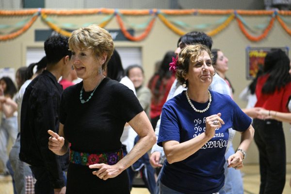 Spanish teachers Diana Moss and Isabel Garcia dance the cumbia to Baila Esta Cumbia by Selena. Attendees also danced the salsa at the end of the night in a competition.