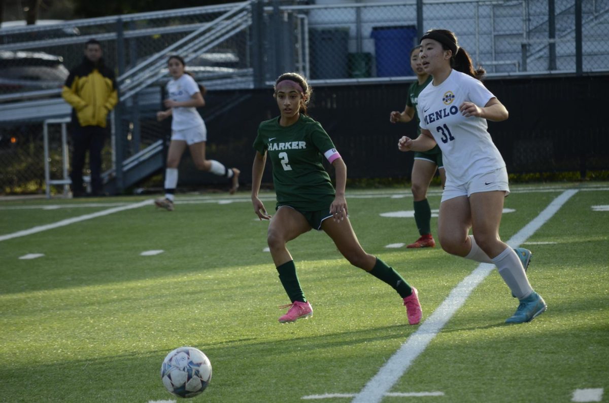 Midfielder and co-captain Anya Chauhan (12) looks to regain possession of the ball from Menlo School. Both teams scored in the second half of their game on Jan. 1st, 2023 to end the match 1-1.