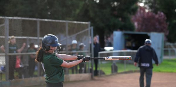 Pitcher and shortstop Raeanne Li (9) follows through with her swing after hitting the softball. “If you only have a few good people, you can’t win games like that. Raeanne said. The whole team has to support each other.” 