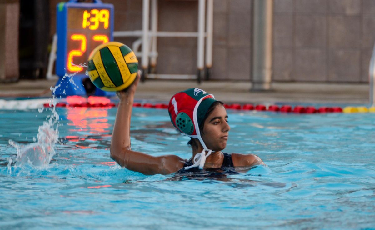 Jasmine Hansra (10) prepares to throw the ball to her teammates across the pool. The varsity girls water polo team defeated Lynbrook 19-4 on Sept. 14th, 2023.