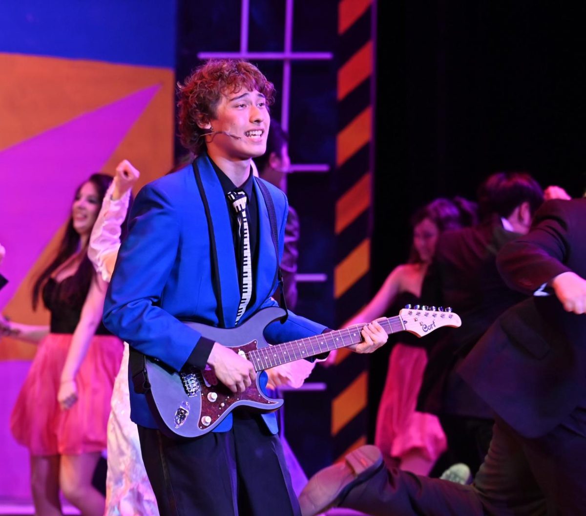 Ian Ogden (12)’s Robbie Hart plays the electric guitar while singing “When It’s Your Wedding Day.” “This musical is very lead-heavy,” Ian said. “It took me a while to get to know my character and all his mannerisms.