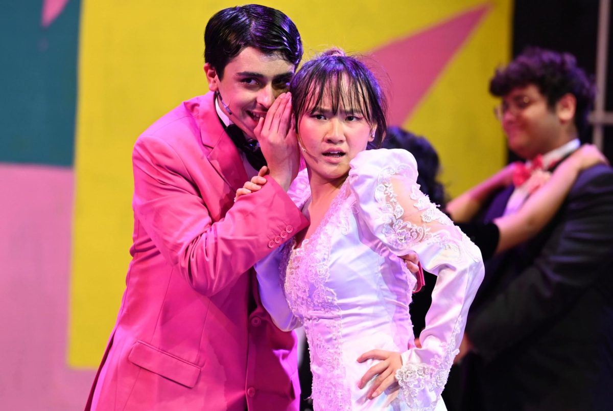 Omar Khan (9), as the groom, whispers to Jessica Skylar-Chen (9), the bride, during an opening scene of the “Wedding Singer.” The musical unfolds across a frenzied sequence of festivities.