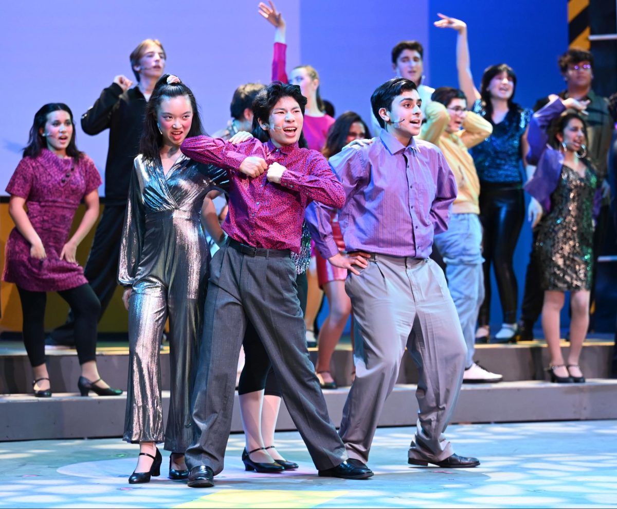 Sophia Zhu (9), Evan Yuan (9) and Omar Khan (9) dance in “Saturday Night in the City.” Closing the first act, the number features water dropping from the ceiling.