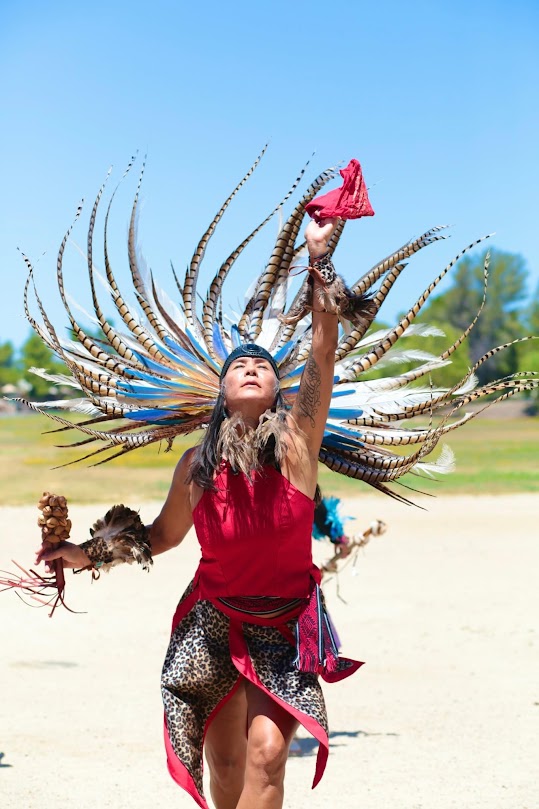 Rae Ann Prado stretches skyward during her dance. She co-founded Aztec dance group Calpulli Ocelocihuatl in 2023. (Provided by Rae Ann Prado)