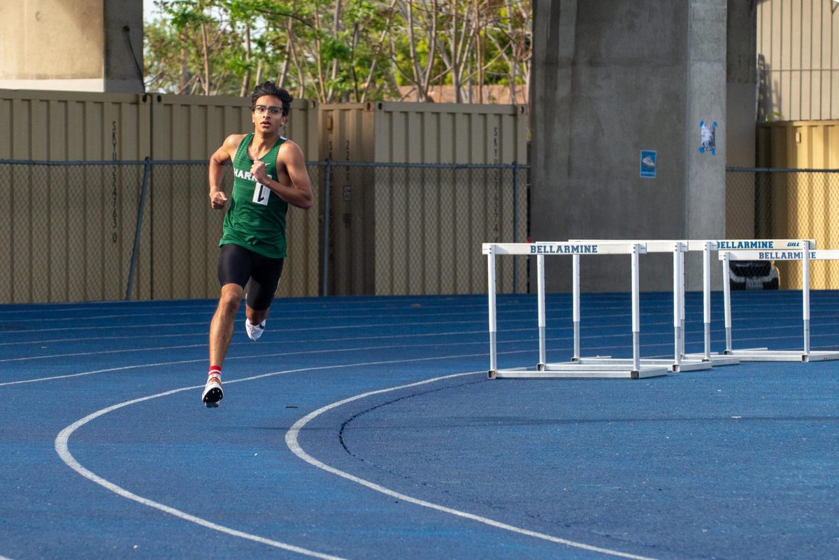 Varsity track and field co-captain Veyd Patil (12) pumps his arms while sprinting. "Running is euphoric," Veyd said. "Everything is just out of this world, and you have a greater appreciation for everything."