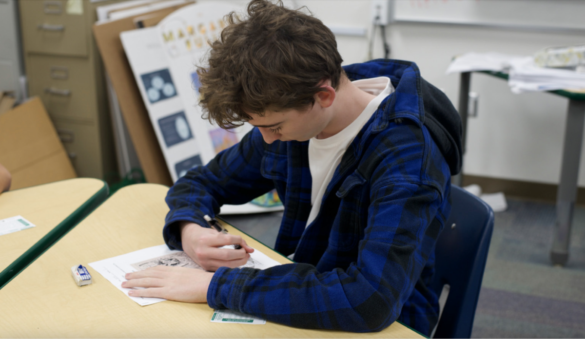 Robert Fields (11) completes a quiz in AP U.S. History. Some colleges are reinstating requirements for standardized test scores that they removed during the pandemic.
