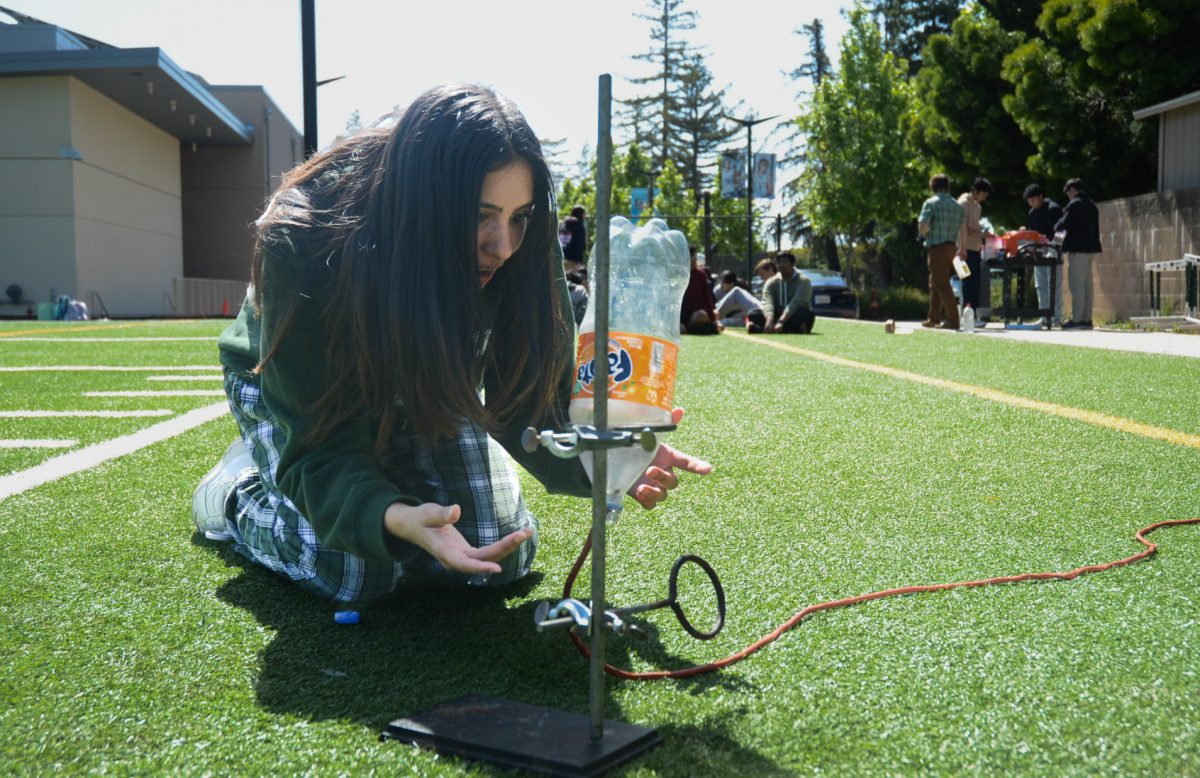 AP Chemistry student Disha Gupta (10) sets up her hydrogen rocket lab on Davis field. Many types of plastic bottles were used in this experiment, including soda bottles and milk jugs.