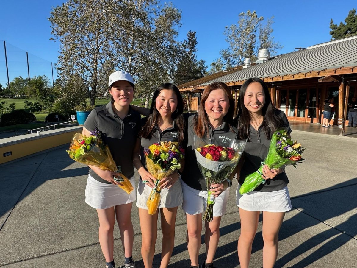 Seniors Katelyn Hsu, Emi Fujimura and Metrica Shi smile with their coach Ie-Chen Cheng. The team plays in a lighthearted nine-hole round at Los Lagos golf course every year.