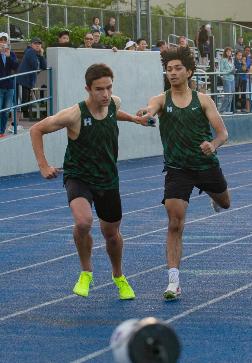 Rushil Jaiswal (11) passed on the baton to Adam Sayed (12) in the 4x400 relay race. 