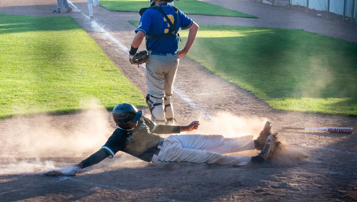 Junior Aarav Borthakur slides safely to home base. The Eagles scored 17 runs against the Grizzlies during their senior night game. 