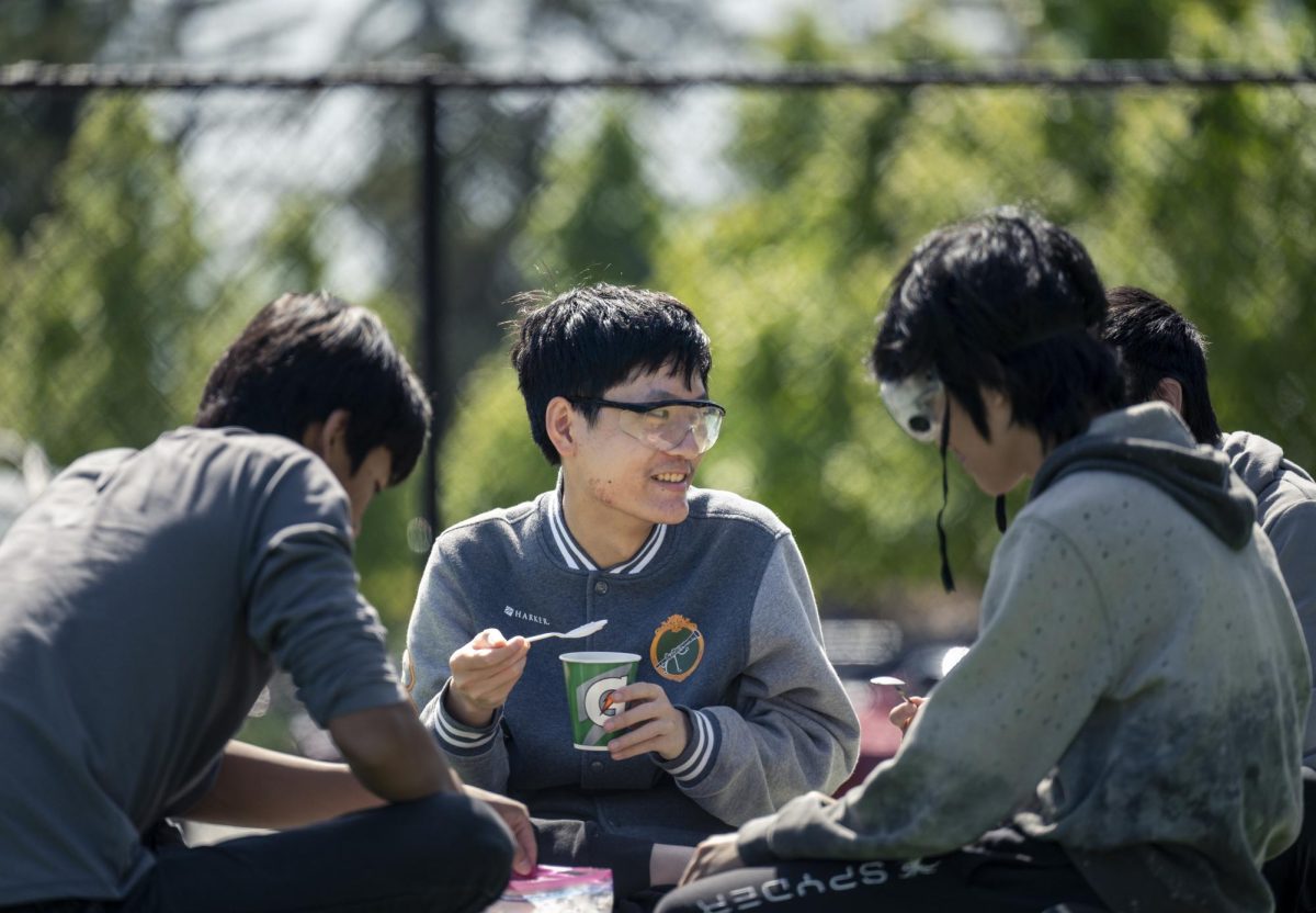 Benjamin Xia (10) savors his ice cream with his friends after watching the classs hydrogen rockets. The ice cream lab reinforced concepts of thermodynamics and energy transfer.