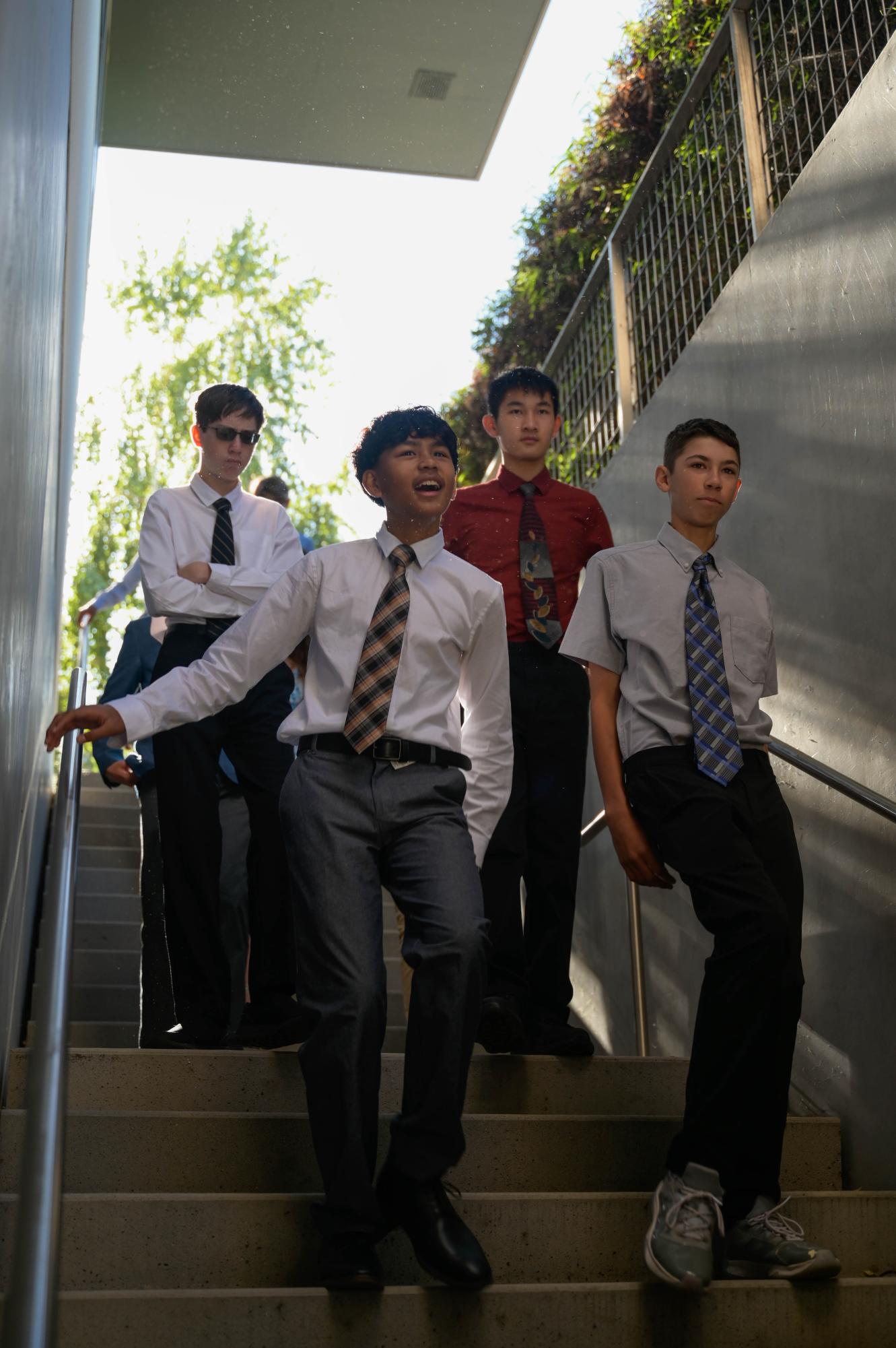 Frosh Kavyon Cruz, Joey Diffenderfer, Brendan Kong and Danny Templeton descend into the Athletic Center. Upperclassmen welcomed the newcomers with a standing ovation. 