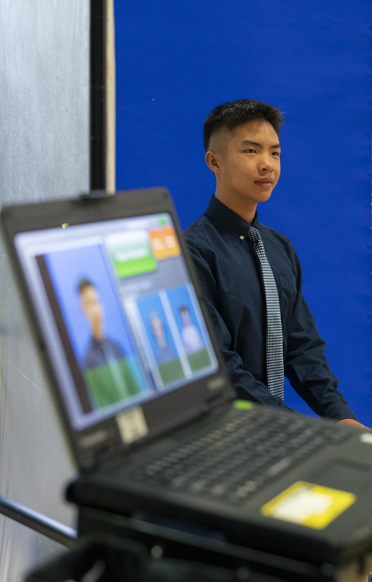 Andrew Woon (9) poses for his student photo. Portraits, orientations and advisory meetings followed Matriculation. 