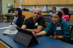 Senior Sriteja Kataru's parents explore the Honors Anatomy and Physiology tablets. Science department chair Anita Chetty teaches the class. 