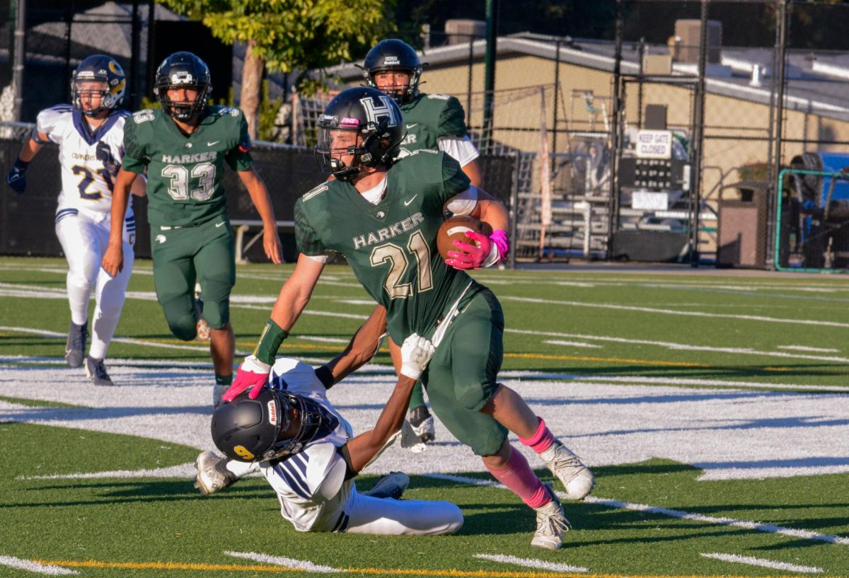 Running back and wide receiver Jackson Powell (11) pushes his way through Cornerstone's defensive line. His teammates assisted by blocking out linebackers and ensuring that Jackson can collapse the distance to the end zone.