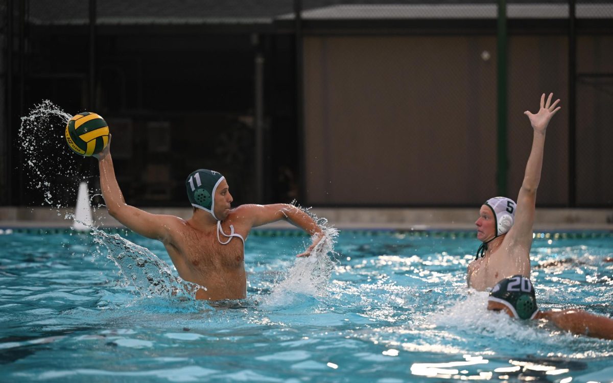 Senior Caio Cammer propels his body out of the water to launch a pass to his teammate. During the second half, the Eagles dominated the Vikings, snapping passes around them and only conceding one goal.