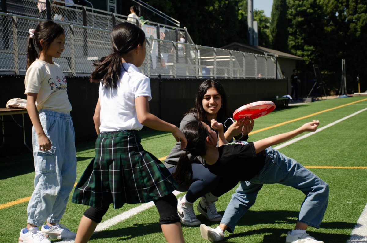 Senior Navya Samuel plays with her Eagle Buddy group on Davis Field. Students had the option to interact with their Buddies on the field, as well as tour the upper school campus. 