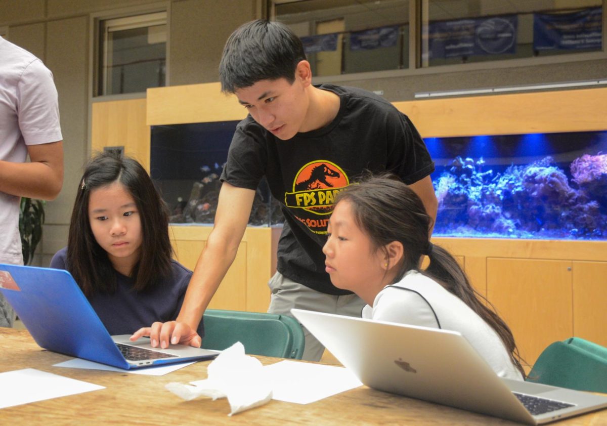 Creative writing, storytelling and skit director Cyrus Ghane explains the process of writing a futuristic scene to FPS Launch attendees. Club members learned how to analyze and solve problems for a scenario set in the future during the introductory event.