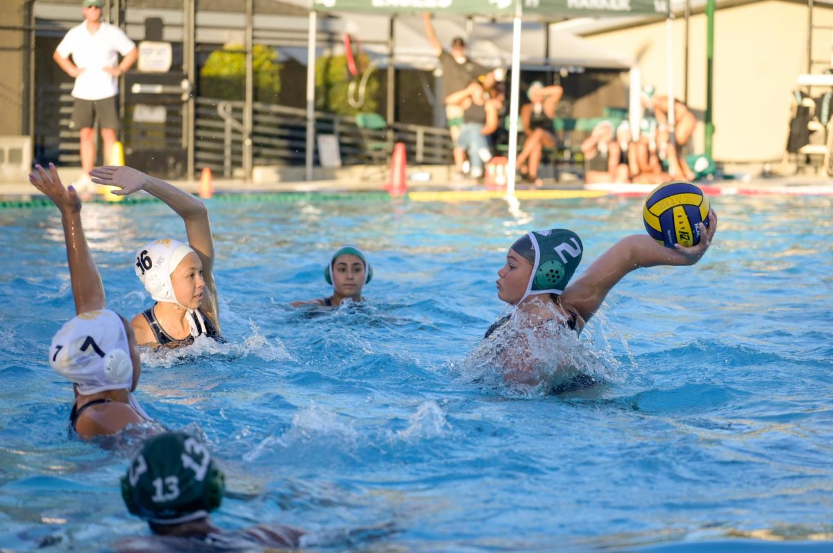 Sophomore Zoe Cammer looks to throw the ball past Mountain View defenders. At the end of the first quarter, the Eagles led 3-0. 