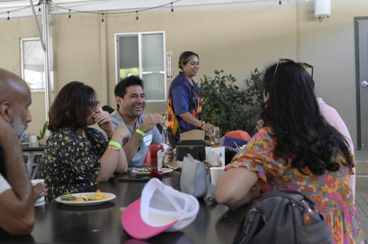 Alumni laugh and catch up during the Barbeque. Other Alumni Weekend events included 5, ten and twenty year reunions.