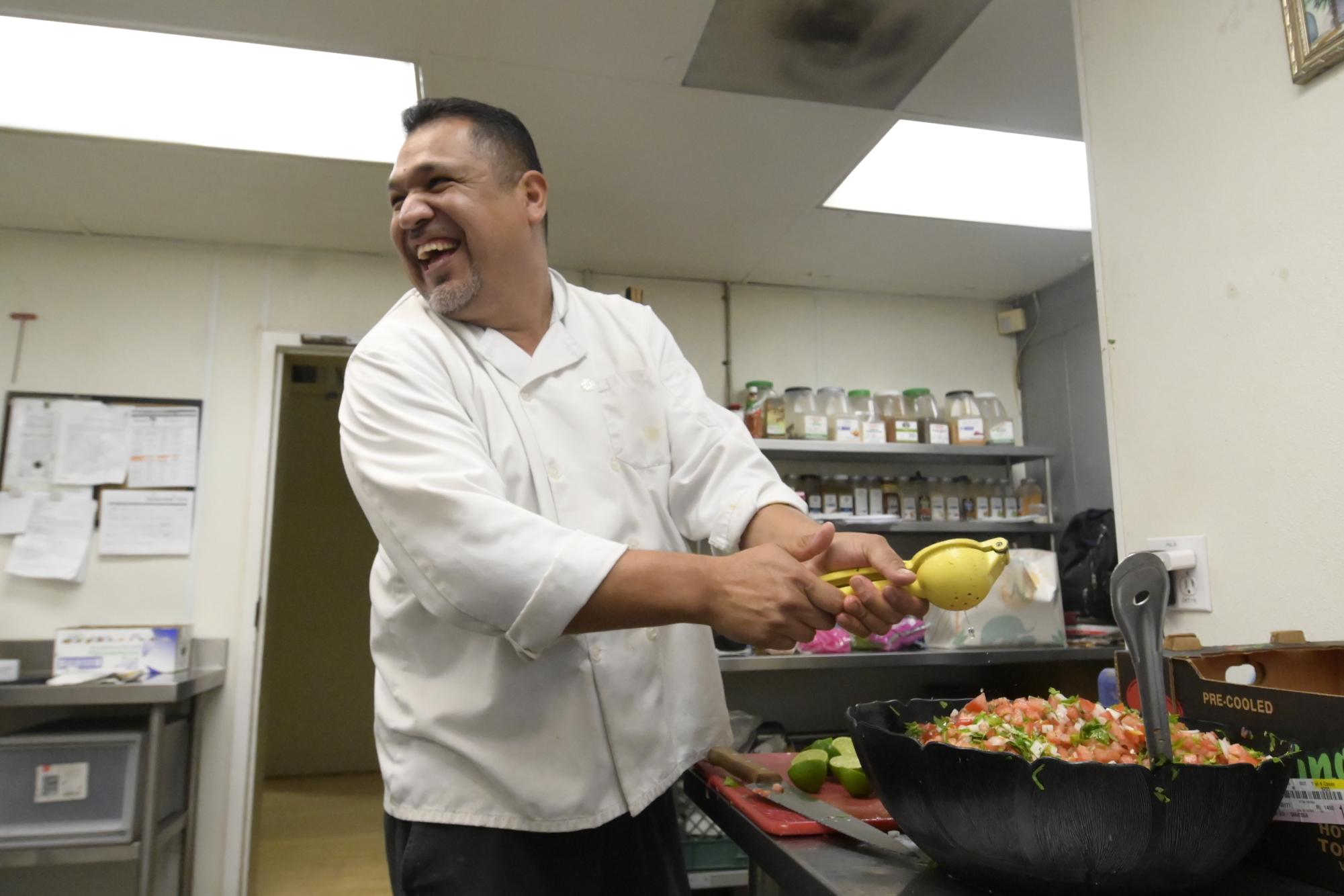 Chef Carlos Madrigal prepares pico de gallo for the Mexican Fiesta condiment bar. Harker receives 125lbs of tomatoes and 300lbs of avocados every week. 