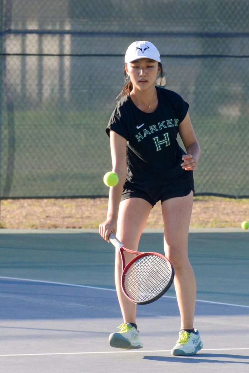 Senior Olivia Guo volleys the tennis ball low during the second set of her doubles match. Olivia G. and her frosh partner Olivia Zhao demolished their opponents 6-2 in the second set. 