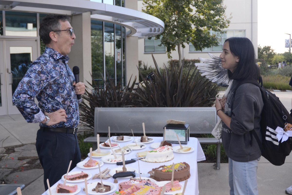 Sophomore Megha Unny smiles at Head of Upper School Paul Barsky's reaction to her answer to his question. She told him that her current favorite book was "Fake Dates and Moon Cakes" by Sher Lee.