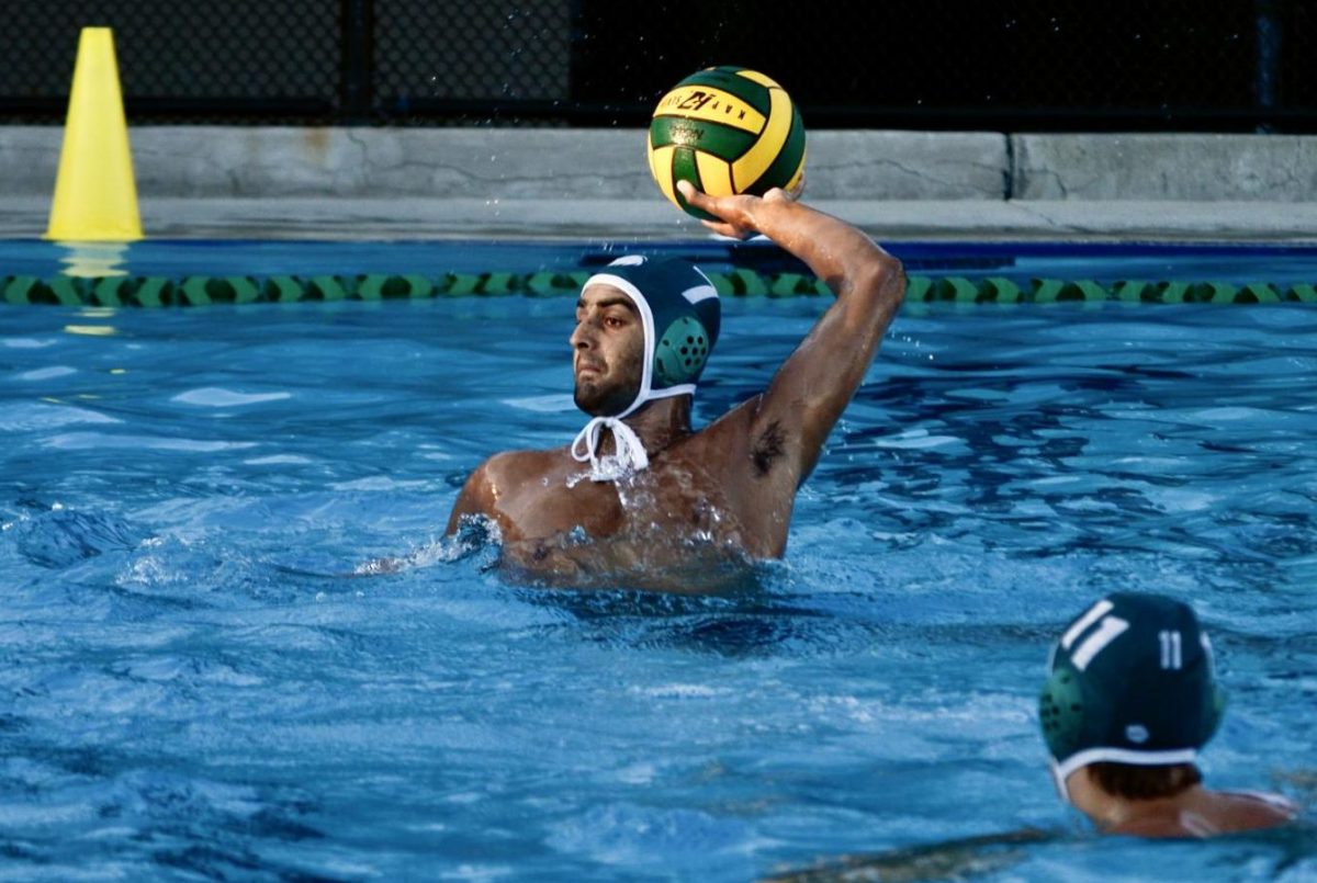 Captain Vyom Vidyarthi (12) holds the ball overhead to launch a pass. Vyom's leadership and defense were key in limiting Gunn's offense, holding them to just five goals throughout the match.